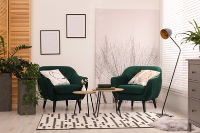 Comfortable armchairs and nesting tables in stylish room