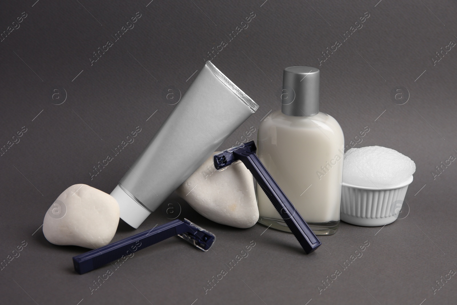 Photo of Different men's shaving accessories on dark grey background