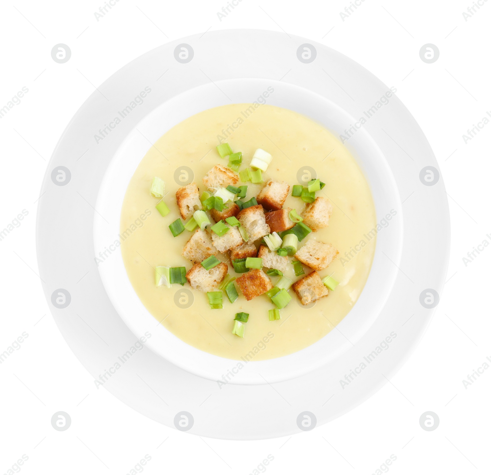 Photo of Tasty potato soup with croutons and green onion in bowl isolated on white, top view