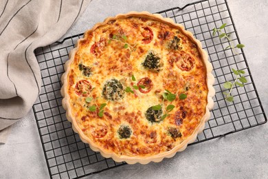 Photo of Delicious homemade quiche on light gray table, top view