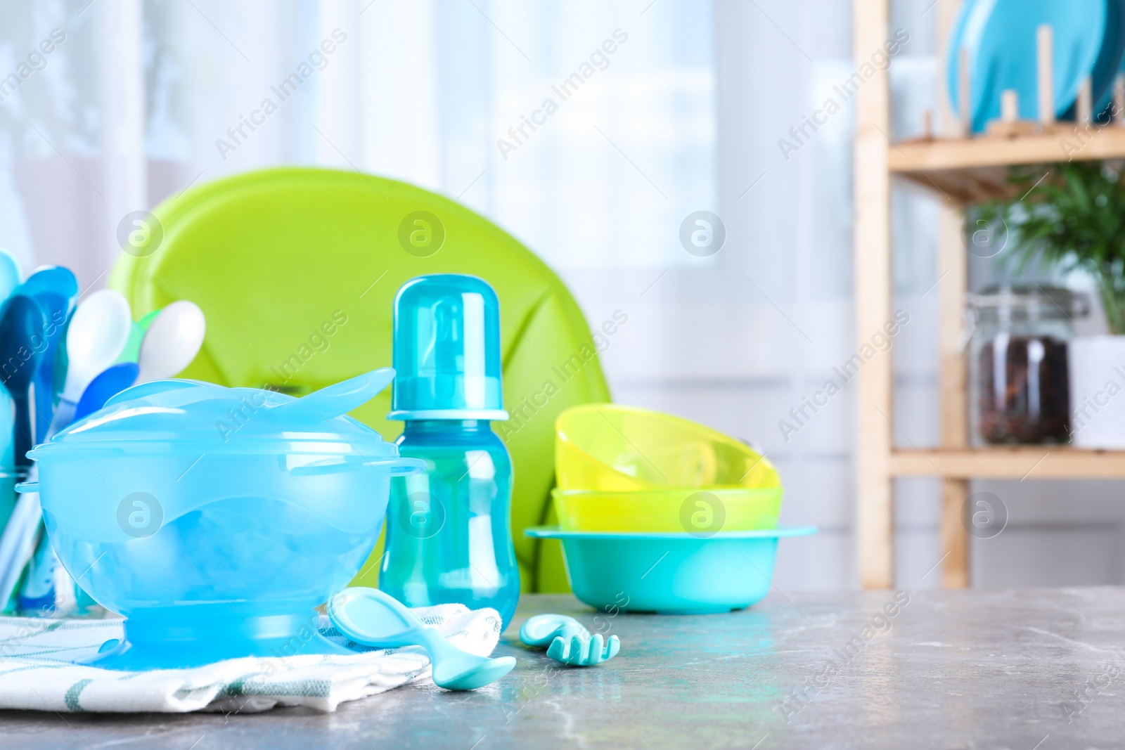 Photo of Bright child's dishware on grey table indoors