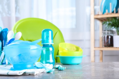 Photo of Bright child's dishware on grey table indoors