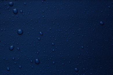 Many water drops on bright blue background