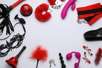 Photo of Frame of sex toys and accessories on white background, flat lay. Space for text