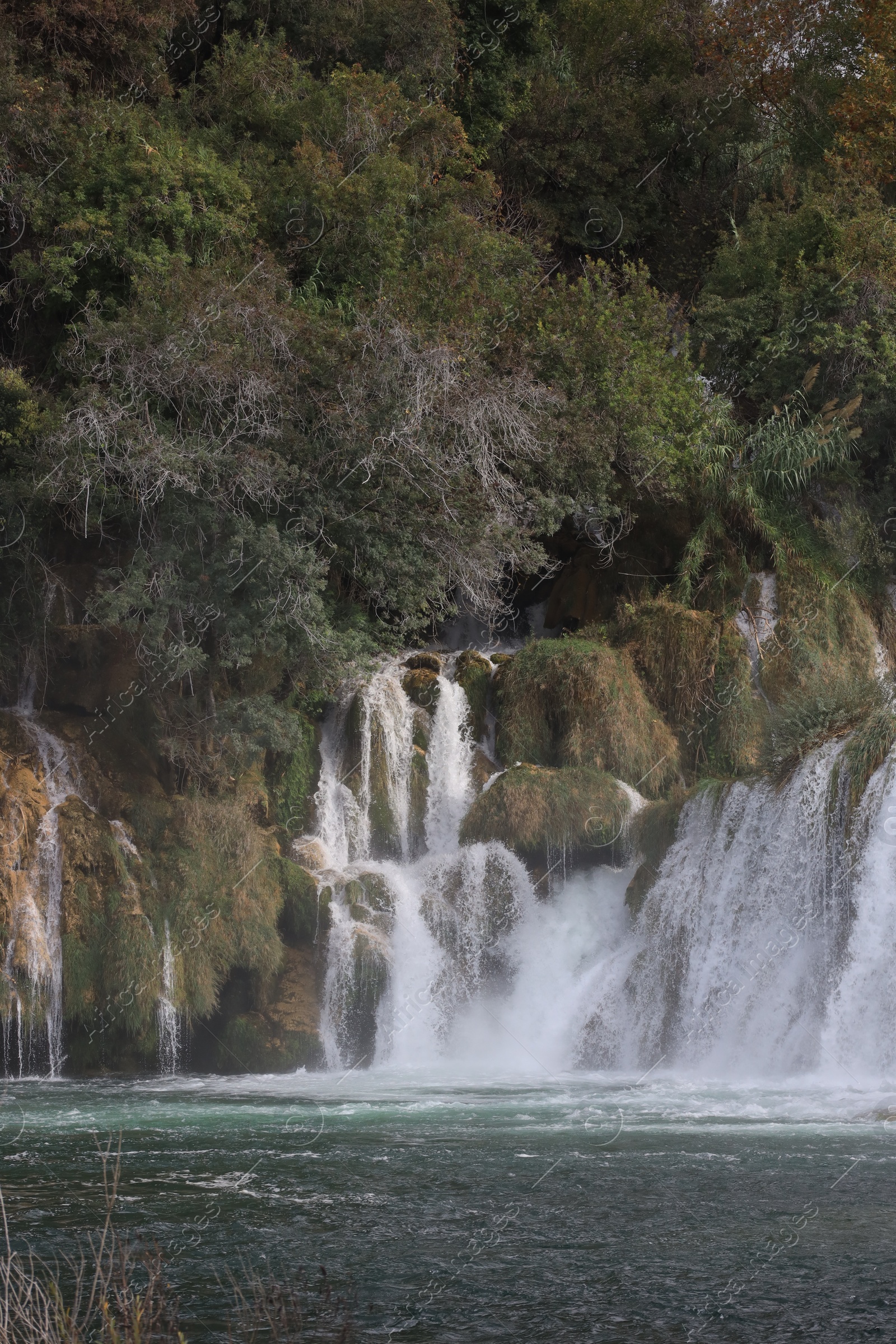 Photo of Picturesque view of beautiful waterfall and rocks outdoors