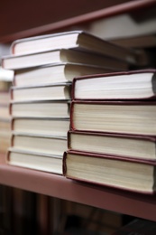 Photo of Stacks of books on shelf in library
