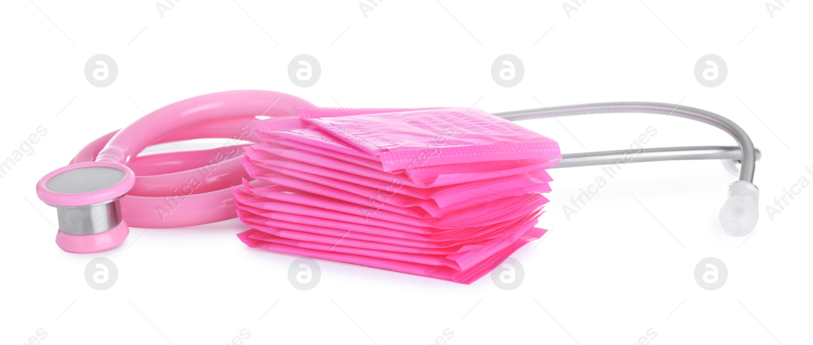 Photo of Stethoscope and menstrual pads on white background. Gynecology concept