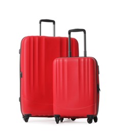 Photo of Red suitcases for travelling on white background