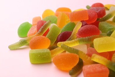 Photo of Pile of colorful jelly candies on pink background