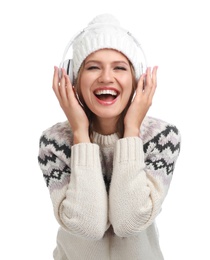 Young woman listening to music with headphones on white background