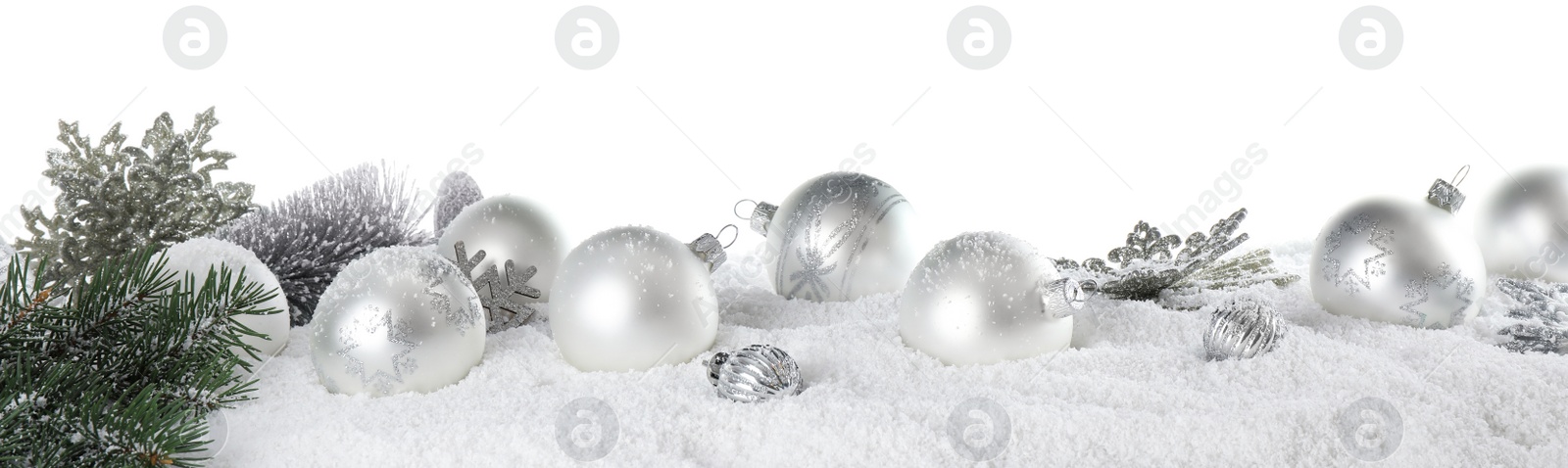 Photo of Christmas decoration on snow against white background