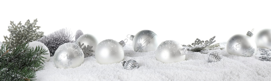 Photo of Christmas decoration on snow against white background