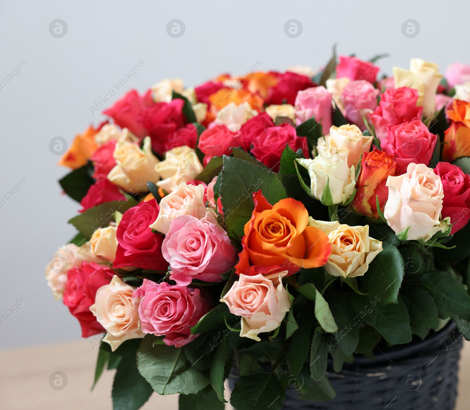 Photo of Bouquet of beautiful roses on light background