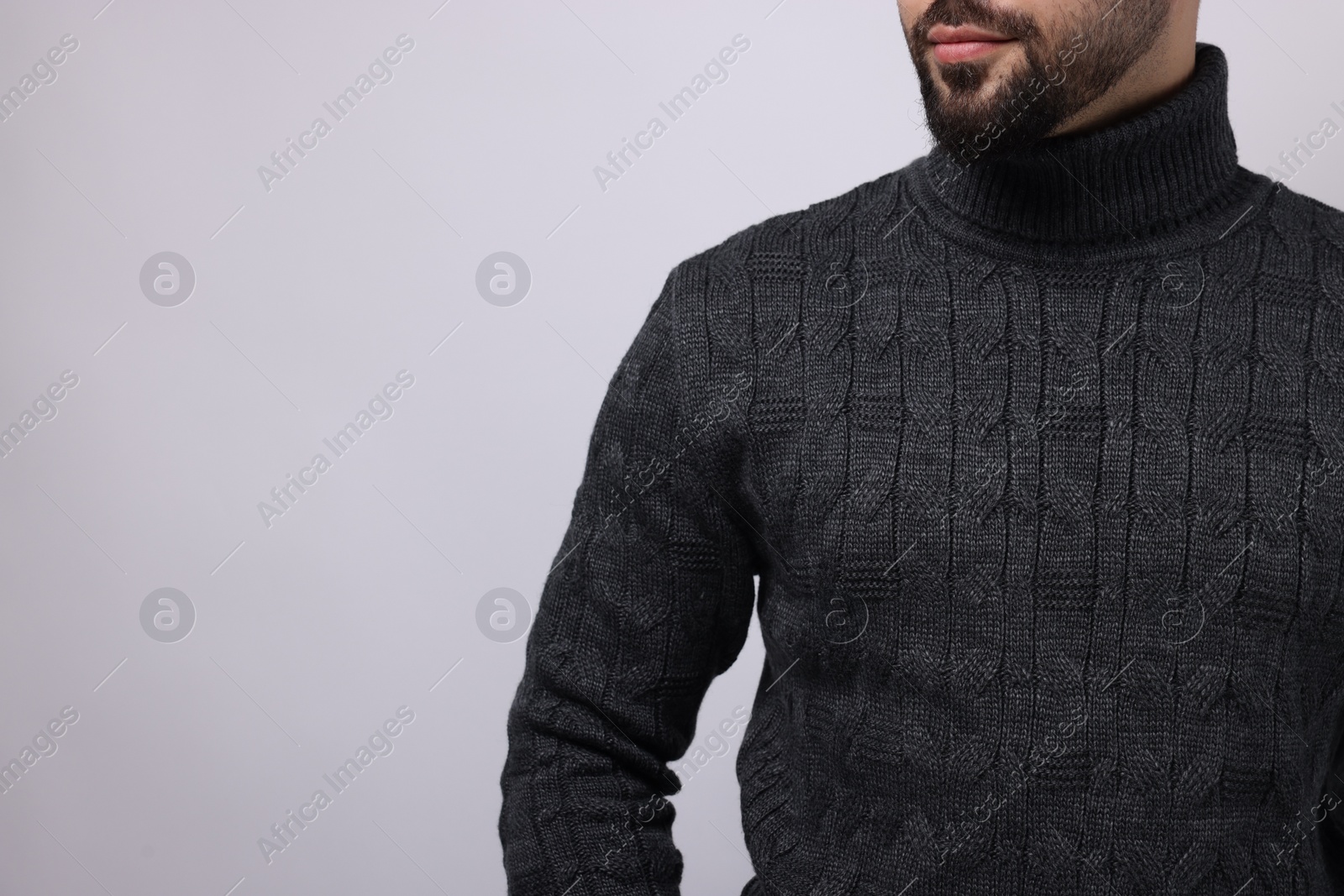 Photo of Man in stylish sweater on white background, closeup. Space for text