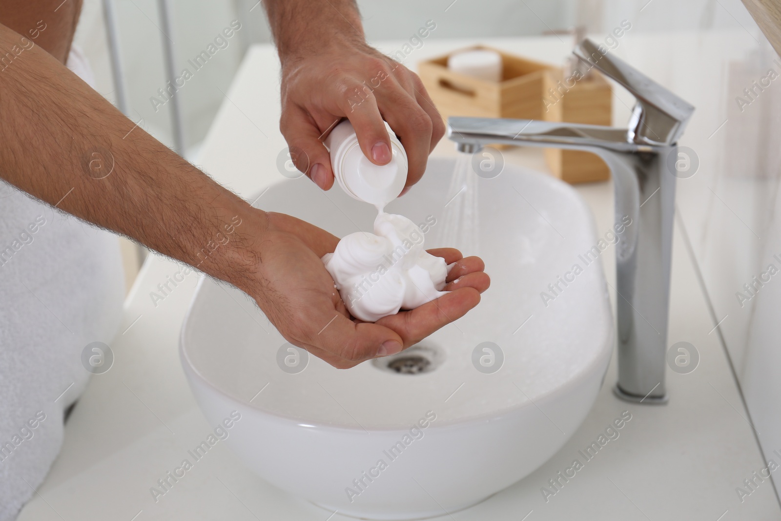 Photo of Man with shaving foam in bathroom, closeup