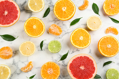 Photo of Flat lay composition with tangerines and different citrus fruits on white marble background