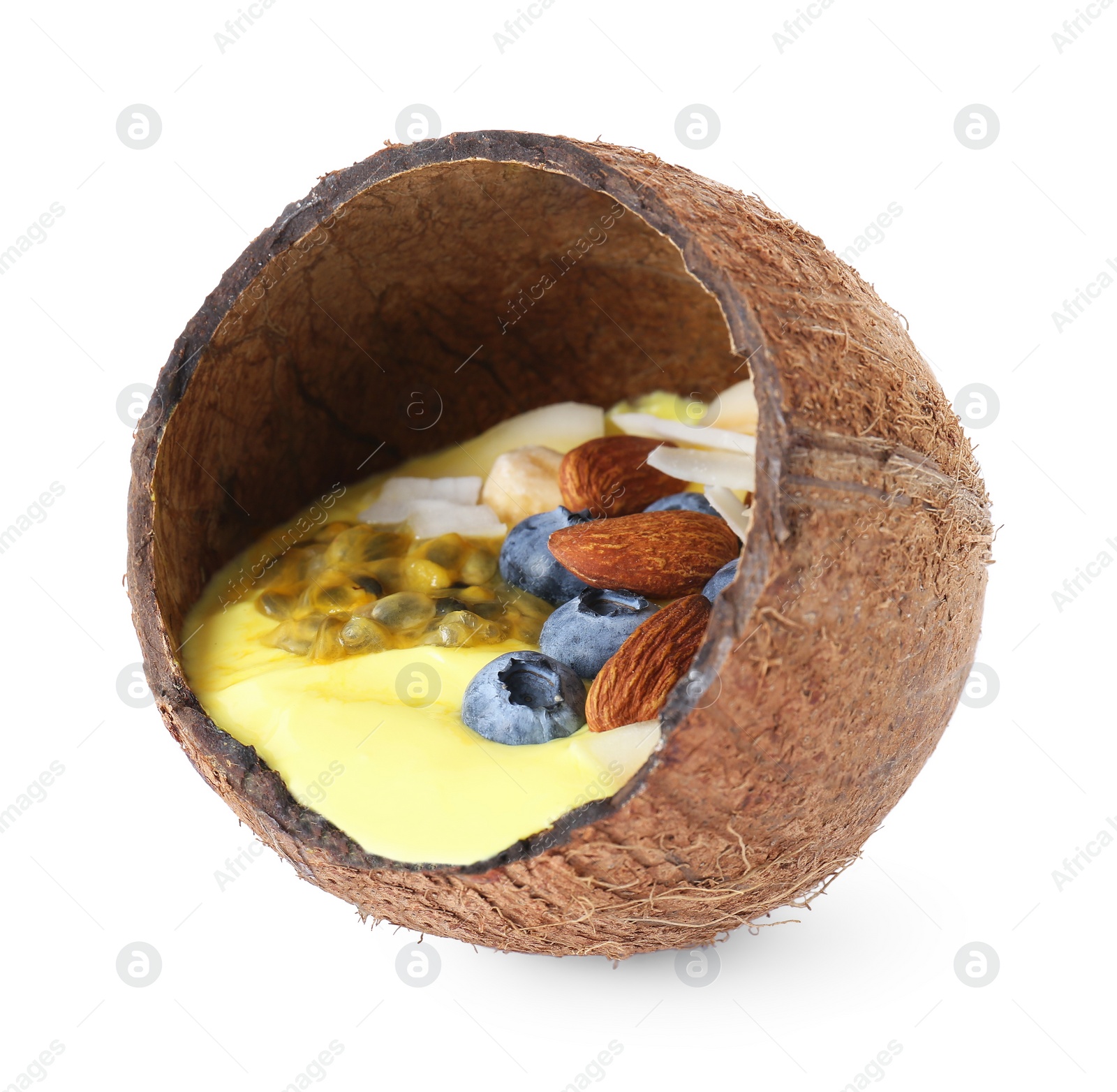 Photo of Tasty smoothie bowl with fresh blueberries and almonds in coconut shell isolated on white