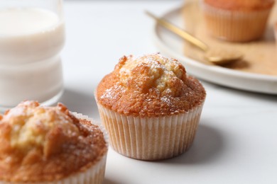 Photo of Delicious sweet muffins on white table, closeup