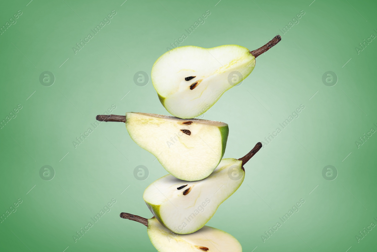 Image of Cut fresh ripe pears on green gradient background