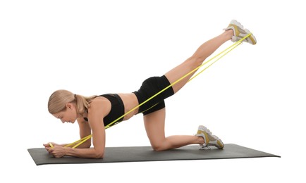 Photo of Woman exercising with elastic resistance band on fitness mat against white background