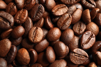 Roasted coffee beans as background, top view