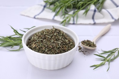Photo of Dry and fresh tarragon on white table, closeup