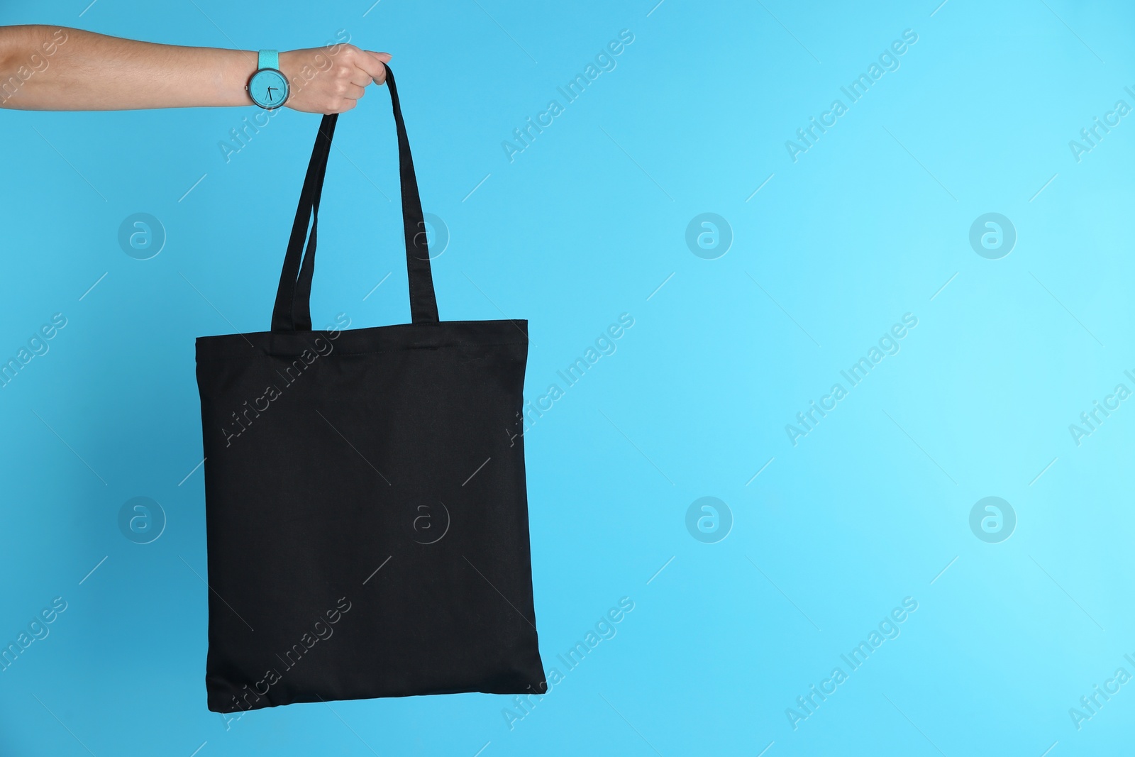 Photo of Woman holding eco bag on color background. Mock up for design