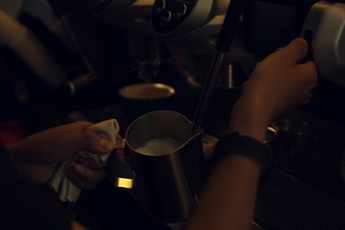 Barista making delicious aromatic coffee in cafe, closeup