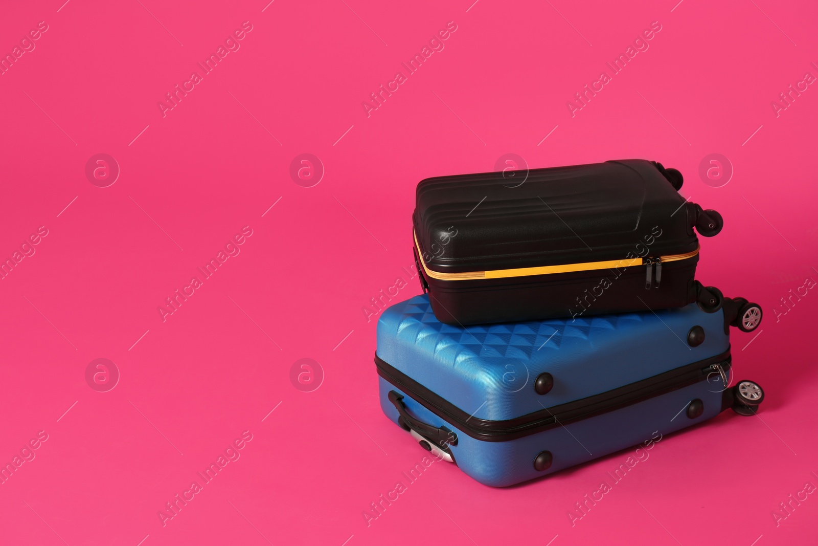 Photo of Stylish suitcases on color background. Space for text