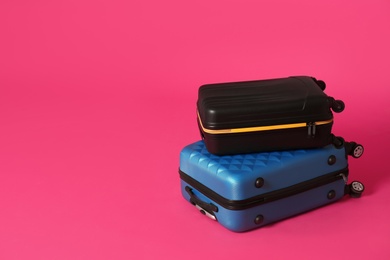 Photo of Stylish suitcases on color background. Space for text