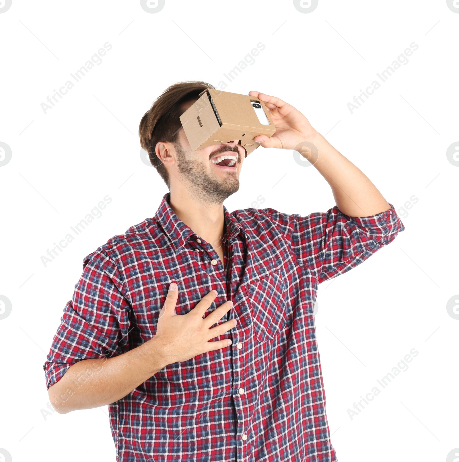 Photo of Young man using cardboard virtual reality headset, isolated on white