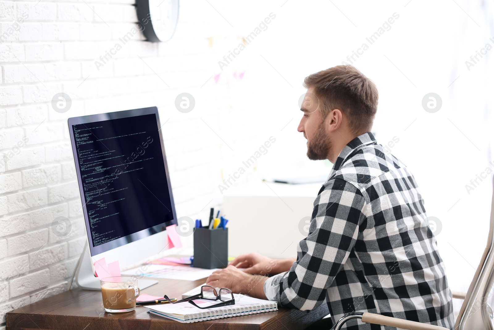 Image of Professional programmer working with computer in office