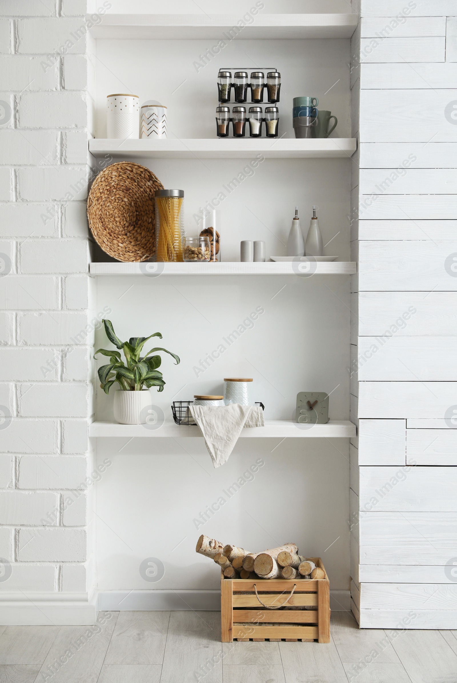 Photo of Many shelves with different decor in room. Interior design