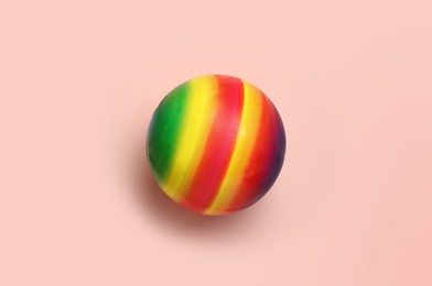 Bright rubber kids' ball on pink background, top view