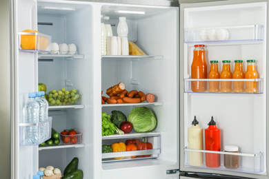 Open refrigerator full of different fresh products