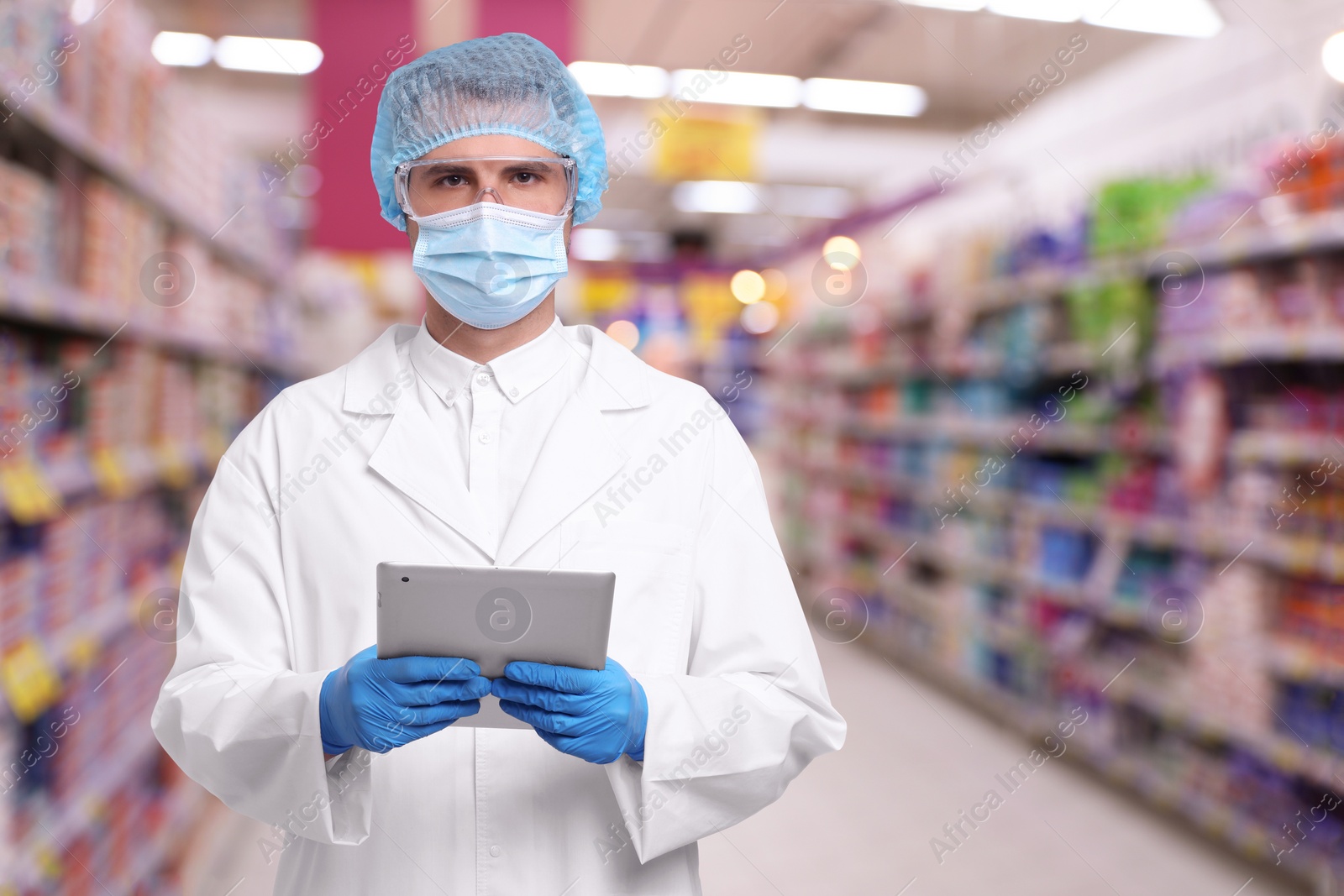 Image of Food quality control specialist examining products in supermarket