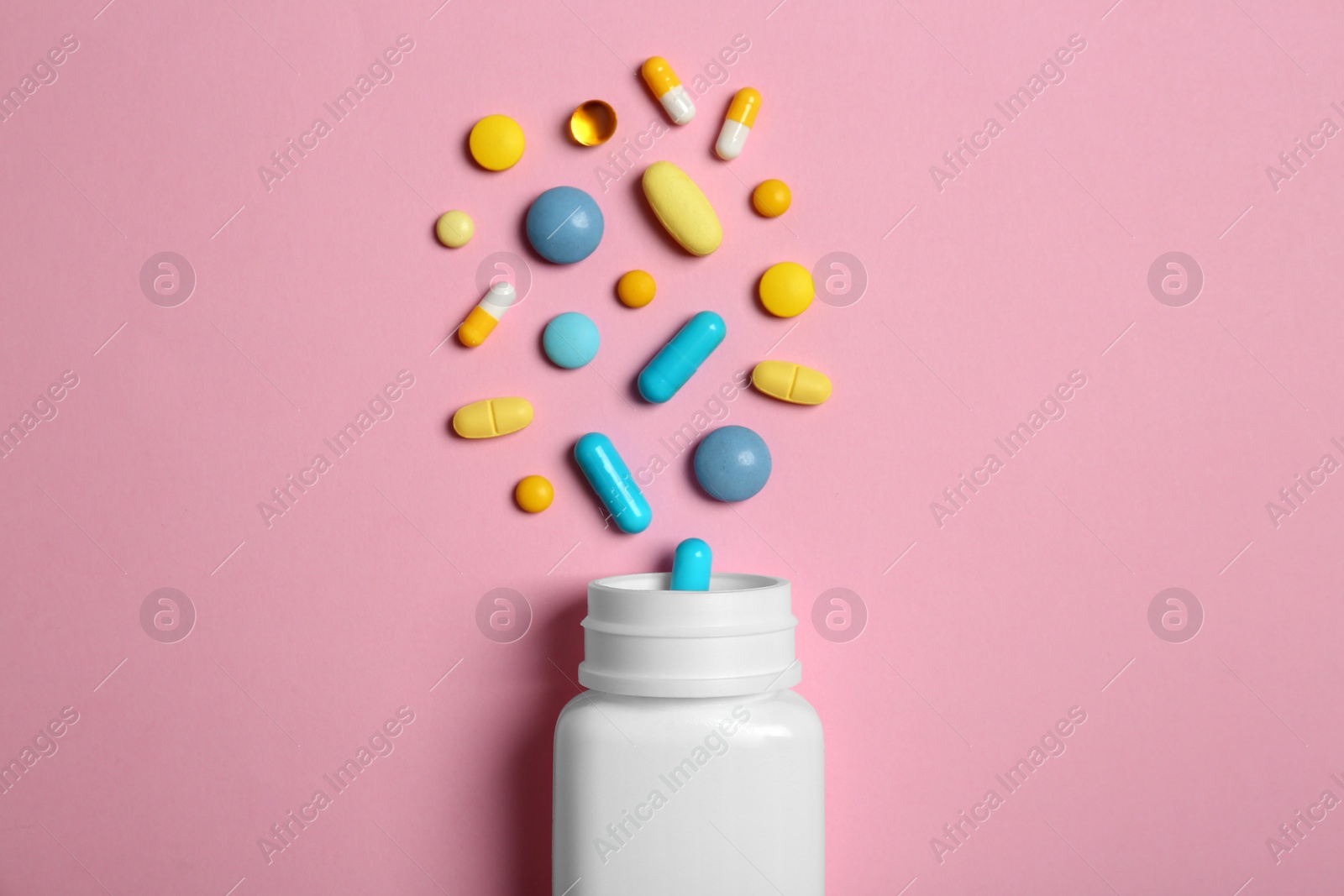 Photo of Flat lay composition with bottle and pills on color background