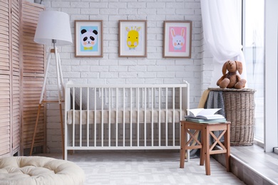 Photo of Modern baby room interior with crib