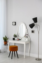 Dressing table with mirror in stylish room interior