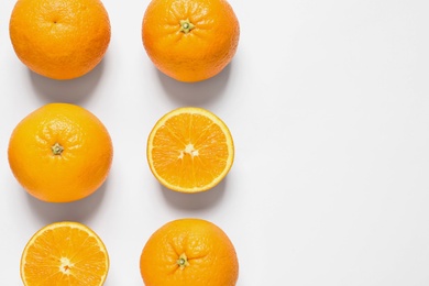 Composition with ripe oranges on white background, top view