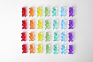 Delicious jelly bears on white background, top view