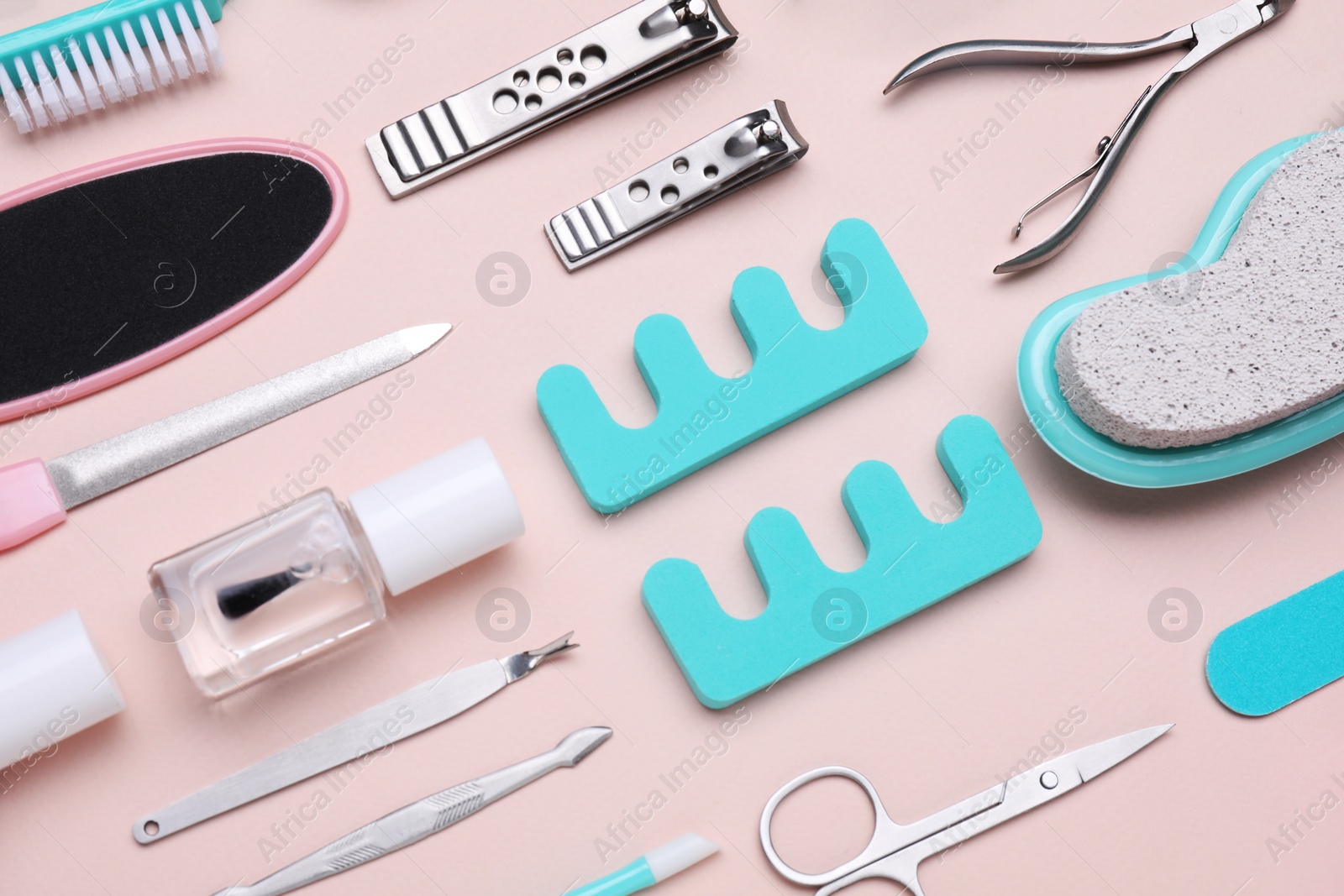 Photo of Set of pedicure tools on pink background, flat lay