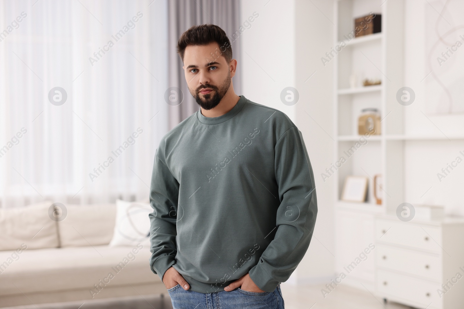 Photo of Handsome man in stylish sweater at home