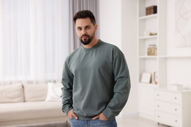 Photo of Handsome man in stylish sweater at home
