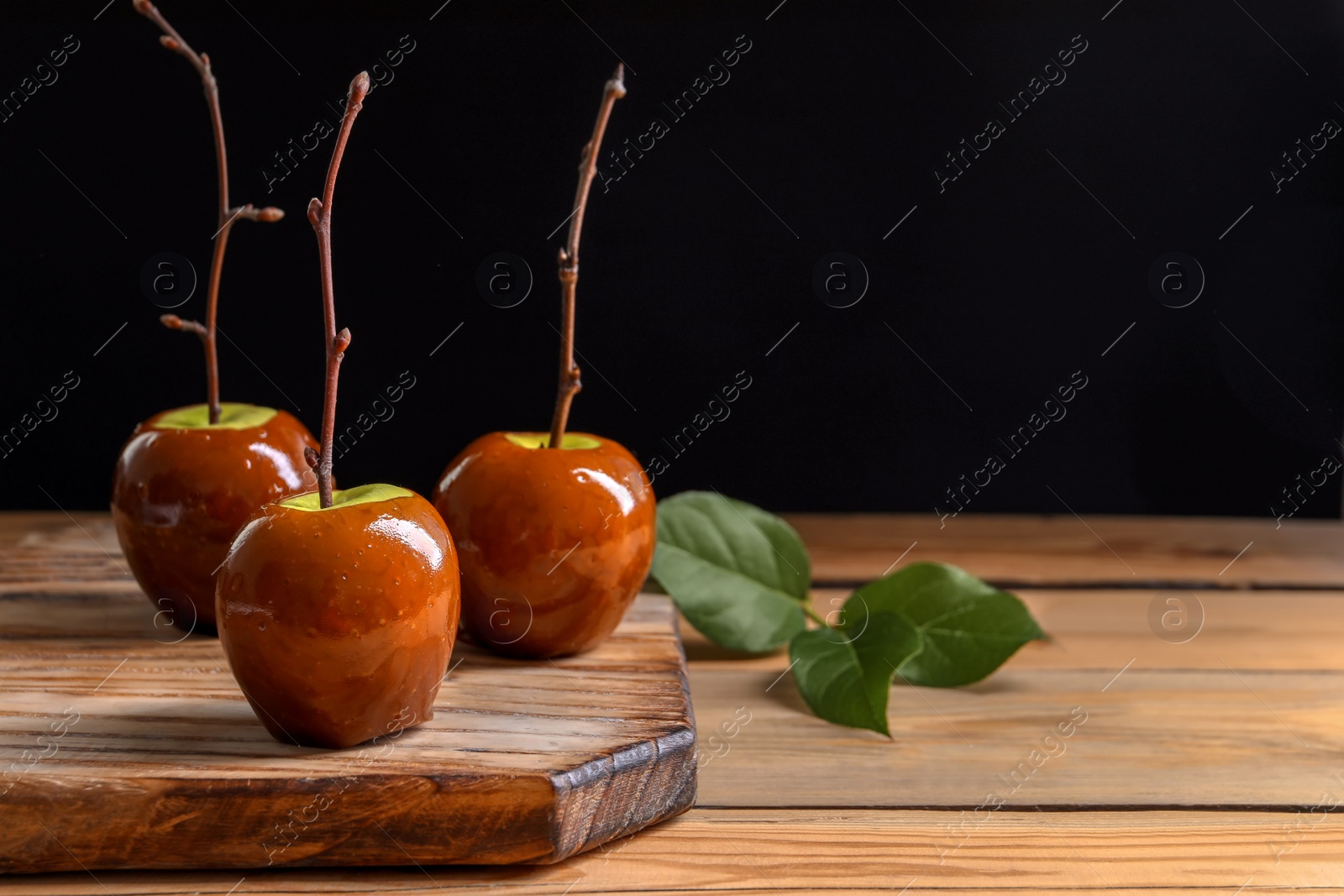 Photo of Delicious green caramel apples on table