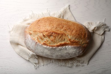 Photo of Loaf of tasty wheat sodawater bread on white wooden table, top view