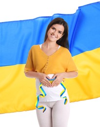 Image of Pregnant woman and Ukrainian flag on white background. Stop war