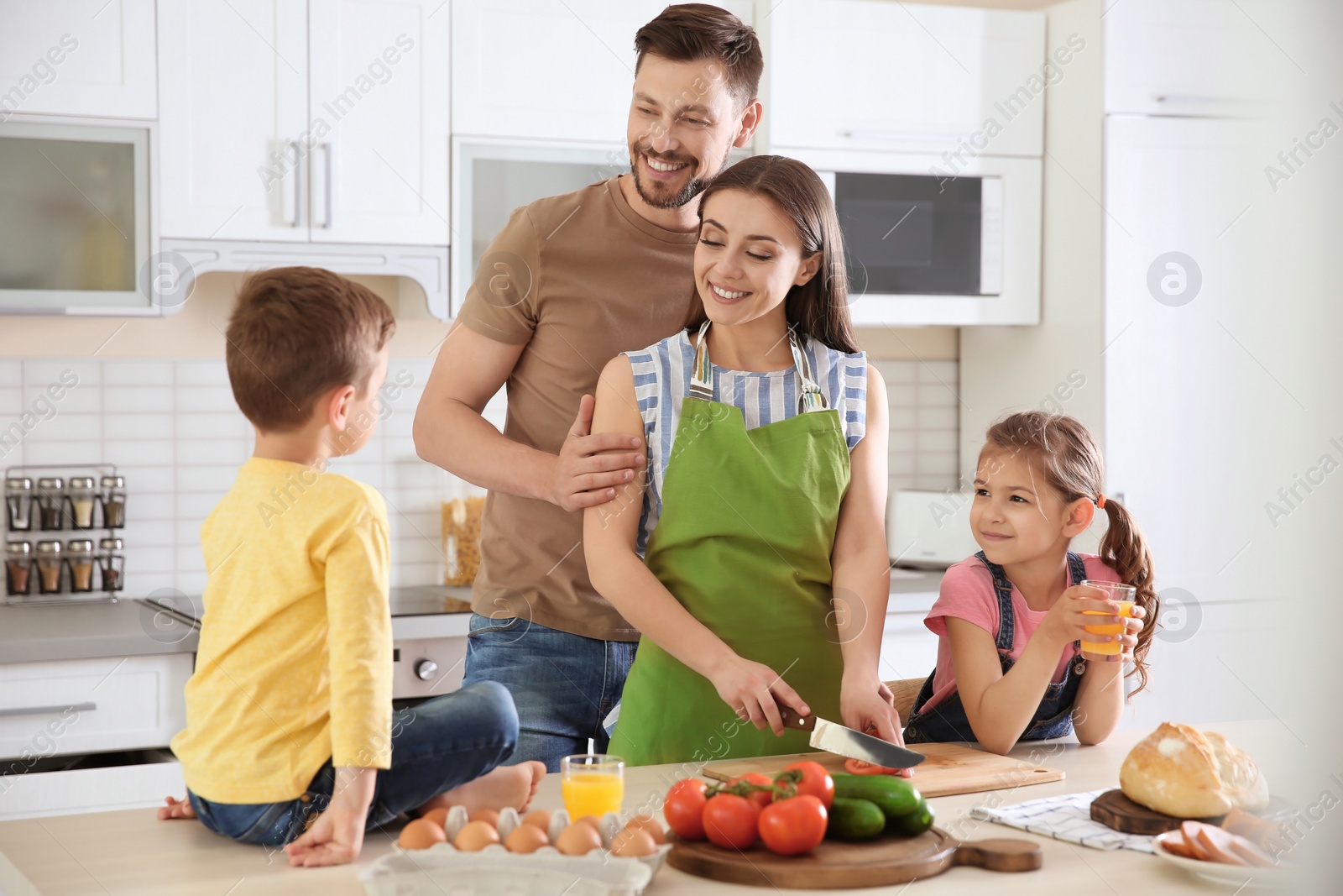 Photo of Happy family with children together in kitchen