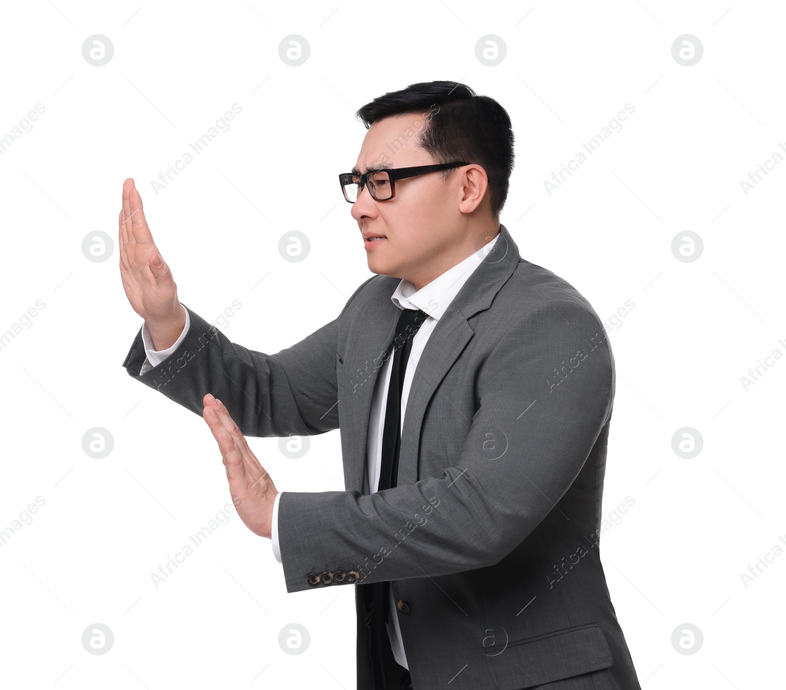 Photo of Scared businessman in suit posing on white background