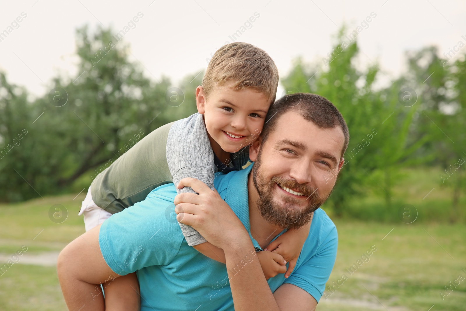 Photo of Man with his child outdoors. Happy family